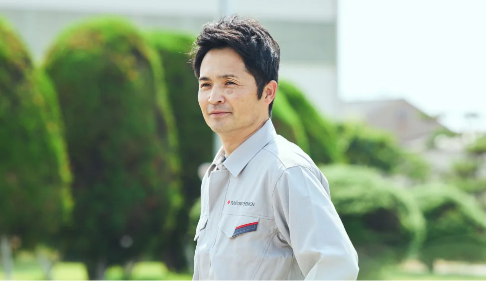 庭園を背に立つS. S.